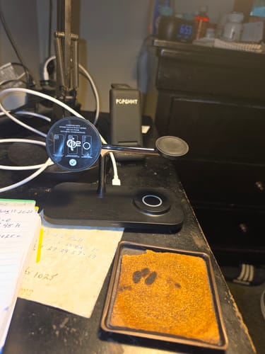 Customer's black MagStation Qi2 charging dock set up on a desk, showing all three charging pads.