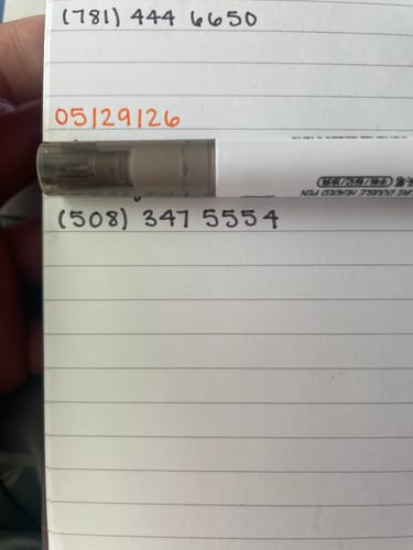 Customer's Dual Line 2-Way Marker on a notepad, showing writing in smooth black and bright orange ink.