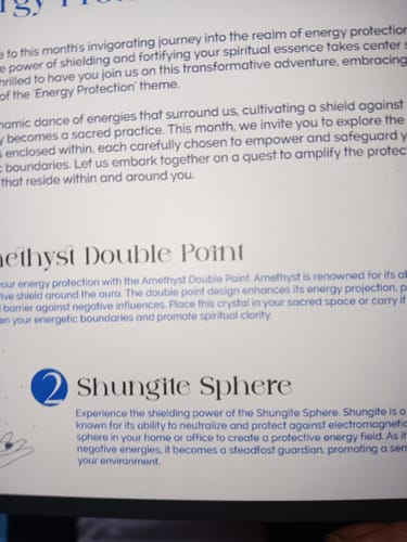 Close-up of the informational card included in the customer's AuraBloom Subscription Box, describing the spiritual items.
