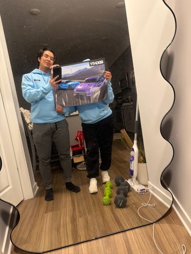 Two customers in matching light blue 80Eighty® Limited Edition DCG87 Hoodies taking a mirror selfie.