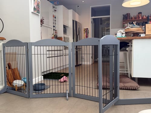 Customer's grey pet playpen set up to create a safe puppy area in a modern home.