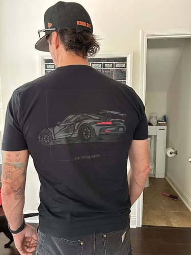Reviewer from behind wearing the black 80Eighty® Mystery Shirt, featuring a large graphic of a sports car on the back.