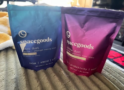 Customer's Day + Night Combo, showing the blue Astro Dust pouch and the pink Rainbow Dust pouch sitting on a couch.