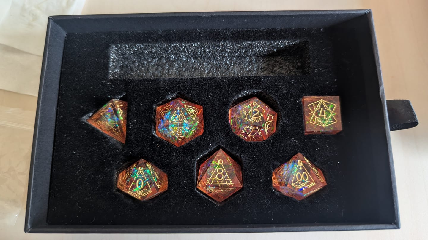 Customer photo review of URWizards D&D Resin Pink Glitter Engraved Dice Set Astrology Style