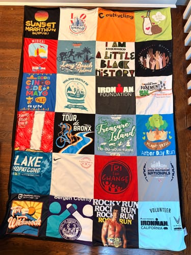 Customer's finished Premium T-Shirt Quilt, made from marathon and triathlon shirts that represent a wellness journey.