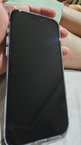 Customer holding a smartphone with the UltraShield Tempered Glass applied, showing its clear, smooth fit.