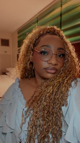 Reviewer wearing voluminous Bobbi Boss Xtra Boho Crochet Braids in a long, blonde style with waves.