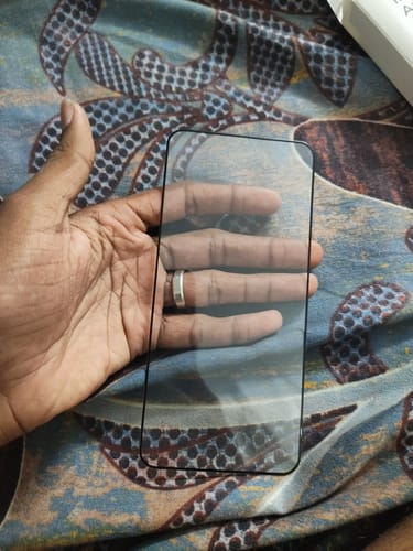 Customer holding a clear protector with a black frame in their hand.
