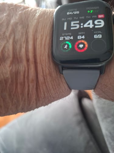 Customer wearing their Health smartwatch 2+. The digital face displays the time, steps, and heart rate on their wrist.