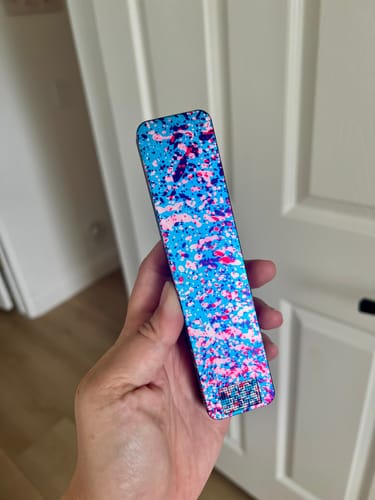Reviewer holding the colorful limited edition Cherry Blossom Weekly Case in their hand.