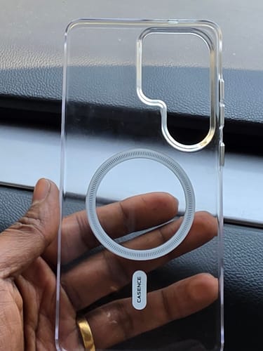 Customer holding a clear phone case with a visible magnetic ring on the back.
