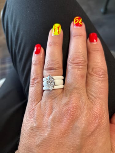 Reviewer's hand wearing the white Marquise Cut CZ Silicone Ring Set against a dark background.