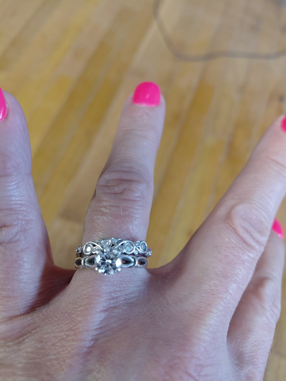 Customer photo review of Bezel Set Round Moissanite Scroll Accents Wedding Band Ring In Sterling Silver
