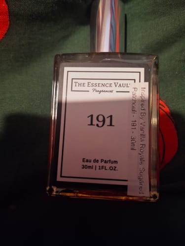 Customer's 30ml bottle of Inspired By Vanilla Royale Sugared Patchouli - 191 perfume on a dark green surface.