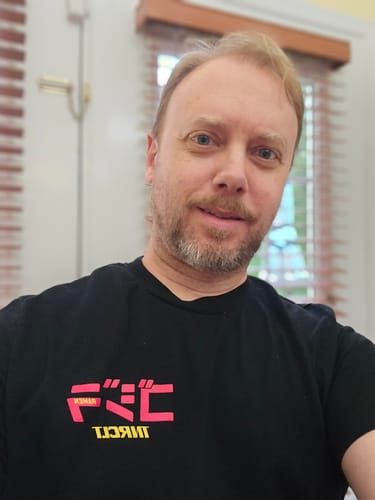 Reviewer wearing the black RAMEN MONSTER TEE, showing the fit and graphic on the chest.