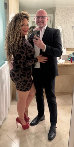 Customer wearing the form-fitting Naked Print Mini Dress with classic print, posing for a mirror selfie.