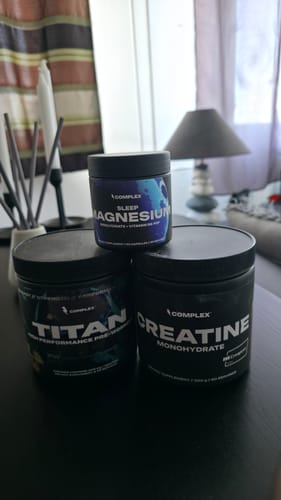 Customer's Creatine Monohydrate tub on a table with two other supplements from the same brand