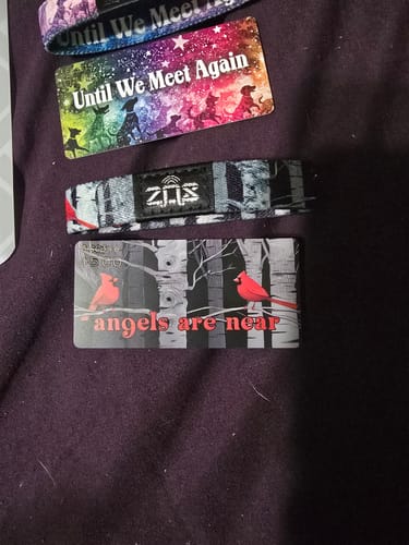Customer's Angels Are Near Bracelet with a red cardinal and birch tree design, laid flat next to its matching card.