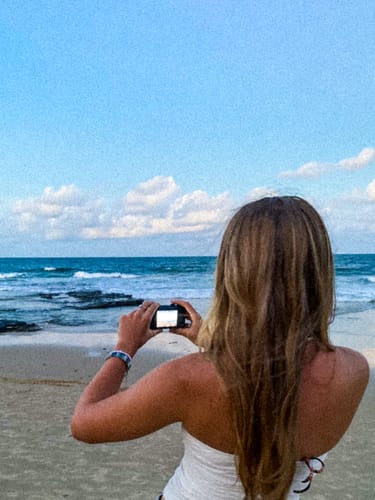 Reviewer on a beach with a glowing, bronze tan.