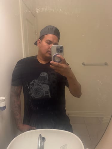 Reviewer wearing the black 80Eighty® BoostForce Shirt in a mirror selfie in their bathroom.