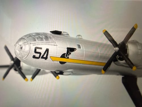Close-up: Reviewer's silver POSTAGE STAMP B-29 model showing the cockpit, propellers, and '54' decal on the nose.