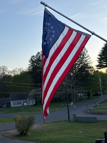 Customer's 1776 to 2026 Betsy Ross Flag flying on a flagpole in a yard.