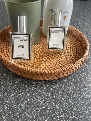 Customer's two bottles of 909 fragrance displayed on a decorative woven tray on a countertop.