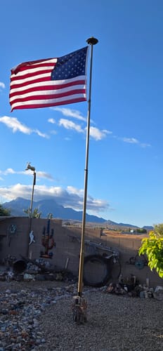 Customer's 1776 to 2026 Betsy Ross Flag flying on a flagpole in their yard against a blue sky.