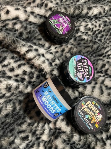 Customer's Haunted Woods body butter displayed with other scents on a fuzzy, animal-print blanket.