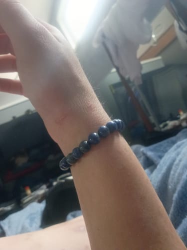 Reviewer wearing the blue crystal bead bracelet from their AuraBloom Subscription Box on their wrist.