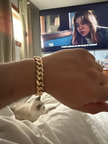 Customer's close-up view of the shiny, gold 14K Cuban Semi Solid Bracelet on their wrist.