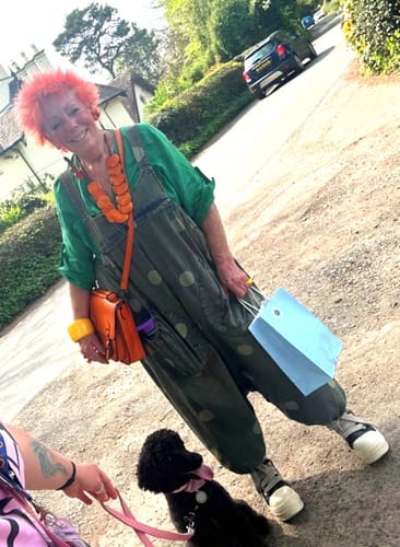 Customer wearing the green Dot Denim Jumpsuit outdoors, styled with a green shirt and bold accessories.
