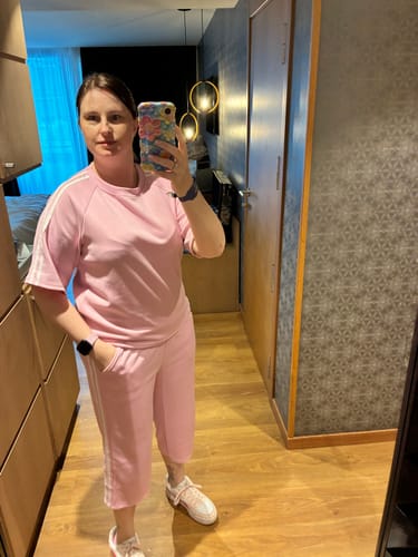 Reviewer in a mirror selfie wearing the Sandy Baby Pink Short Sleeve Set, showing the oversized top and cropped pants.