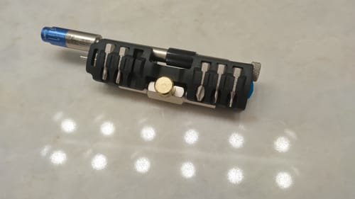 Reviewer's 18-Bit Bracket holding a T-drive wrench and multiple tool bits in a compact setup on a countertop.