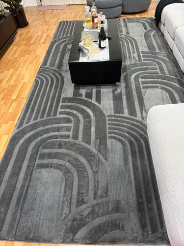Customer's charcoal Mellow Mat with its carved geometric pattern in a living room.