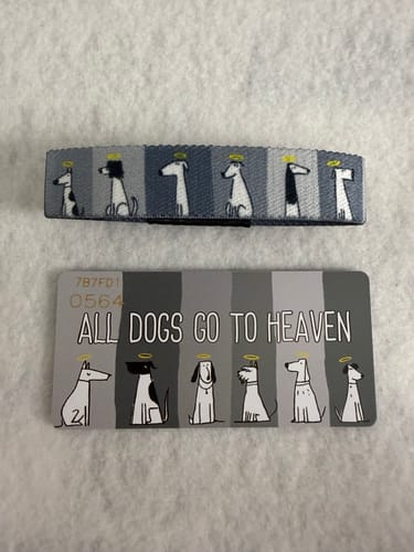 Customer's gray All Dogs Go To Heaven Bracelet and matching collector's card, featuring dogs with halos.