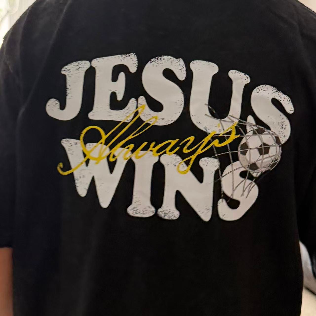 Customer photo review of Jesus Always Wins Football Graphic Tee