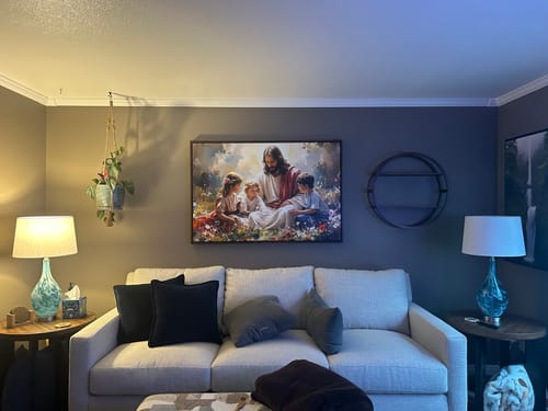 Reviewer's colorful Jesus With Children Faith Wall Art II hanging above a sofa.