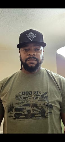 Reviewer wearing the snug-fitting green ENR#79 Limited Edition Tee, showing the front graphic.