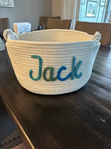 Customer's personalized knitted basket displaying the name 'Jack' in multicolor yarn.