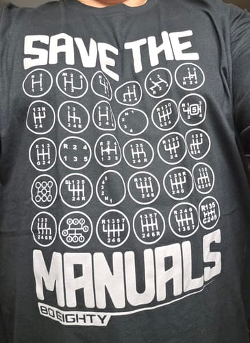 Customer wearing the black Save The Manuals shirt, showing the white graphic of many transmission shift patterns.