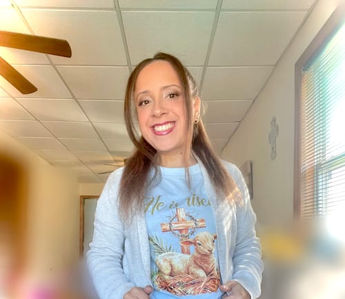 Customer showing the relaxed fit of the blue Lamb & Cross Easter T-Shirt styled with a cardigan.
