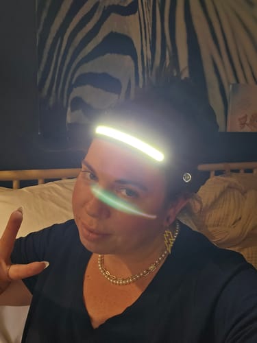 Reviewer taking a selfie while wearing the brightly lit 80Eighty HeadLamp.