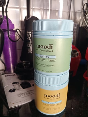 Customer's tubs of Moodi Pre + Probiotic Blend, with the Lemon Lime flavor stacked on top.