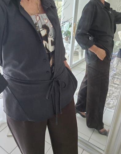 Customer wearing the full-length Lana Trousers in espresso brown, showing the wide-leg fit in a mirror.