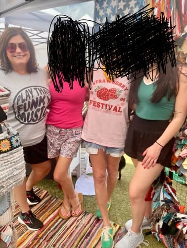 Customer wearing the grey Stay Funky T-Shirt with a 'Play that Funk Music' design, posing with others.