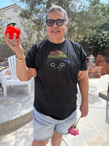 Reviewer smiling outdoors while wearing the black Statement Made Pride t-shirt.