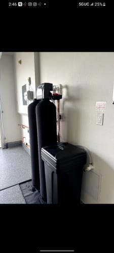 Customer's installed SoftPro water filter system with two large black tanks in a utility room.
