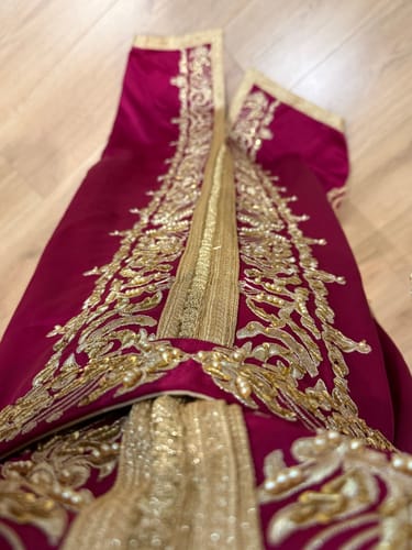 Close-up of the customer's hot pink Caftan Ritaj, showing the intricate gold embroidery and stones.