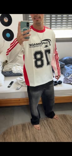 Customer takes a mirror selfie wearing the Jersey Digital Print Colorblock Long-Sleeved T-Shirt with dark jeans.